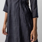 Side closeup midnight wrap dress on model, against a white background.