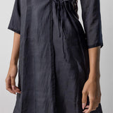 Side closeup midnight wrap dress on model, against a white background.