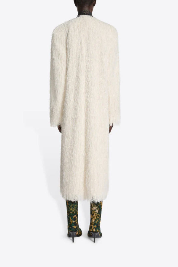 Back view of white Rivla Fringed Coat on model wearing green print boots against a white background.