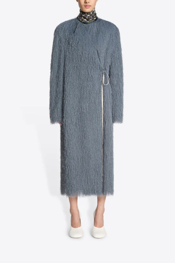 Front view of dark grey Rivla Fringed Coat on model wearing white heels, against a white background.