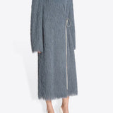 Side view of Dark Grey Rivla Fringed Coat on model wearing white heels, against a white background.