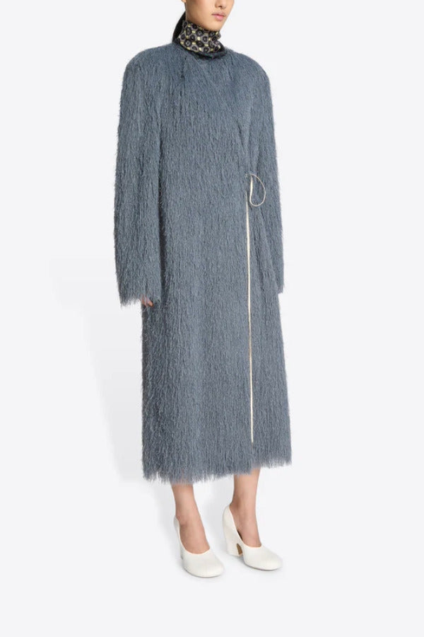Side view of Dark Grey Rivla Fringed Coat on model wearing white heels, against a white background.