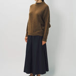 Front slanted view of palissandro cn kimono sleeve sweater on model wearing navy pants, against a white background.