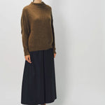 Alternate front view of palissandro cn kimono sleeve sweater on model wearing navy pants, against a white background.