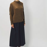 Alternate front view of palissandro cn kimono sleeve sweater on model wearing navy pants, against a white background.