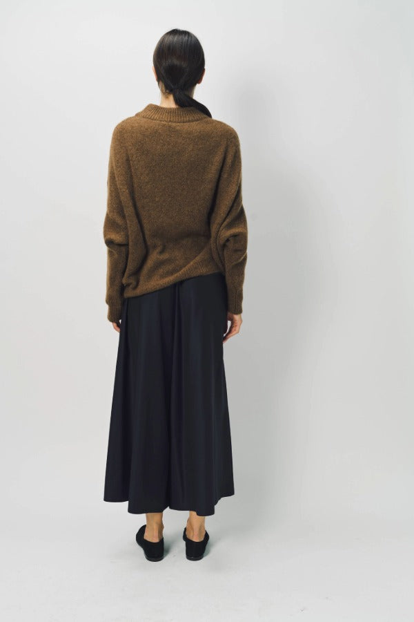 Back view of palissandro cn kimono sleeve sweater on model wearing navy pants, against a white background.