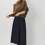 Alternate front view of palissandro cn kimono sleeve sweater on model wearing navy pants, against a white background.
