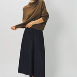 Alternate front view of palissandro cn kimono sleeve sweater on model wearing navy pants, against a white background.