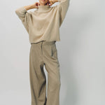 Alternate front view of vanilla cashmere cn kimono sleeve sweater on model wearing sand pants, against a white background.