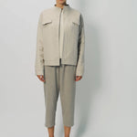 Front view of oatmeal cashmere double face jean jacket on model wearing stone pants, against a white background.