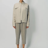 Front view of oatmeal cashmere double face jean jacket on model wearing stone pants, against a white background.