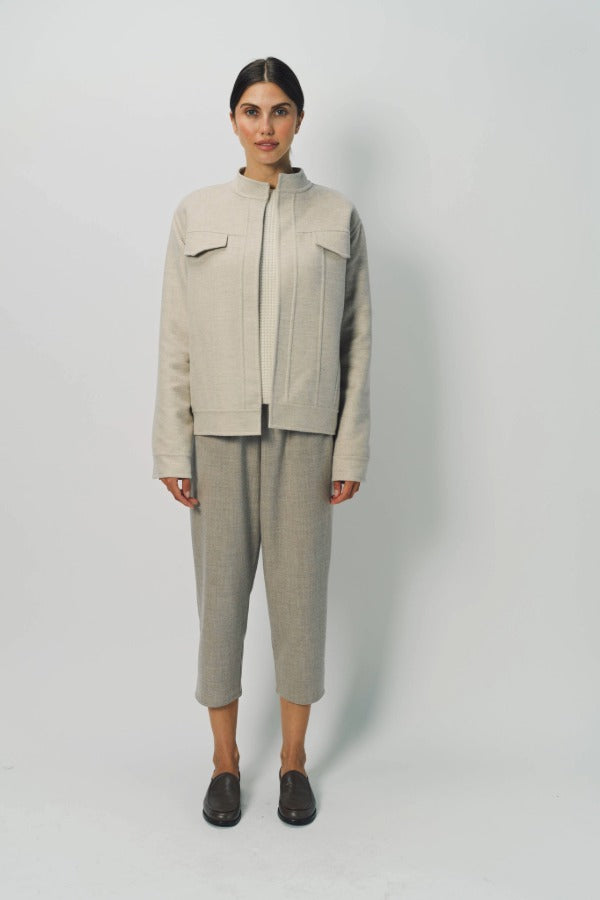 Front view of oatmeal cashmere double face jean jacket on model wearing stone pants, against a white background.