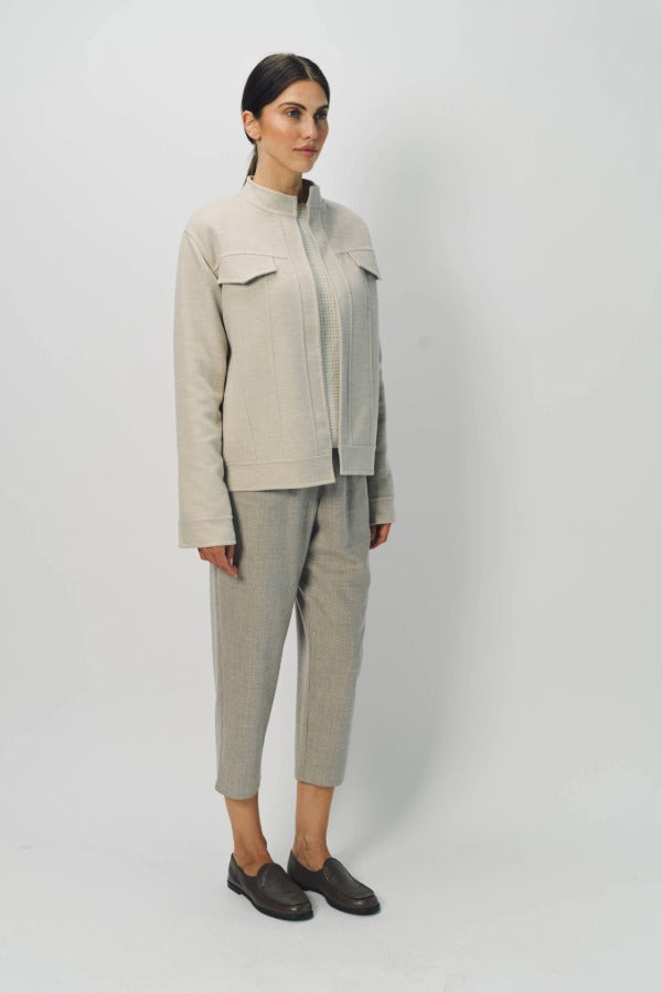 Alternate front slanted view of oatmeal cashmere double face jean jacket on model wearing stone pants, against a white background.