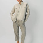 Alternate front view of oatmeal cashmere double face jean jacket on model wearing stone pants, against a white background.