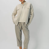 Alternate front view of oatmeal cashmere double face jean jacket on model wearing stone pants, against a white background.
