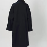 Back view of midnight long kimono coat on model wearing navy pants, against a white background.