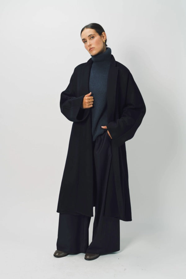Alternate front view of midnight long kimono coat on model wearing navy turtleneck and pants, against a white background.