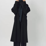 Alternate front view of midnight long kimono coat on model wearing navy turtleneck and pants, against a white background.