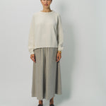Alternate front view of bone ls crew neck sweater on model wearing grey pants, against a white background.
