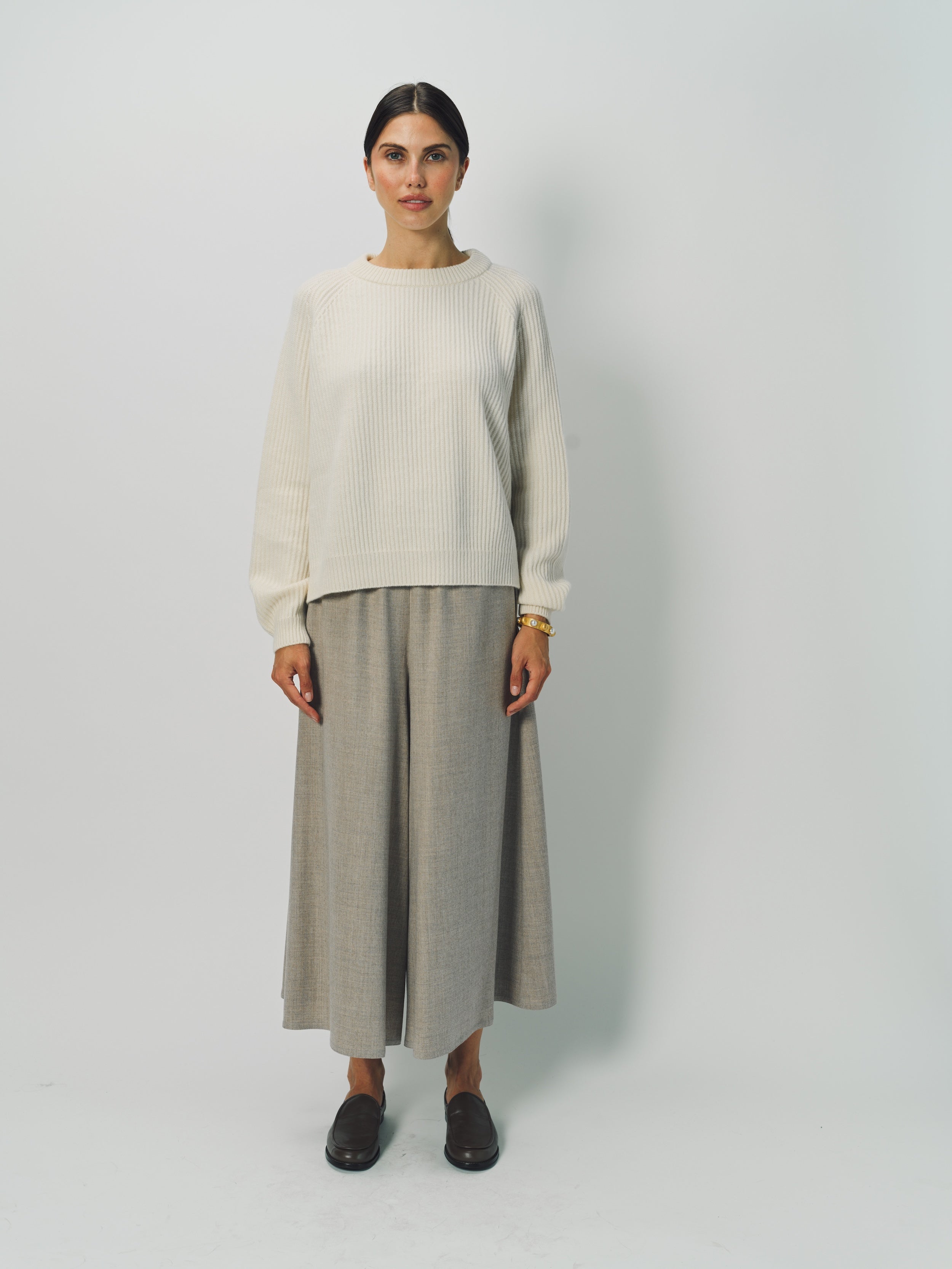 Alternate front view of bone ls crew neck sweater on model wearing grey pants, against a white background.