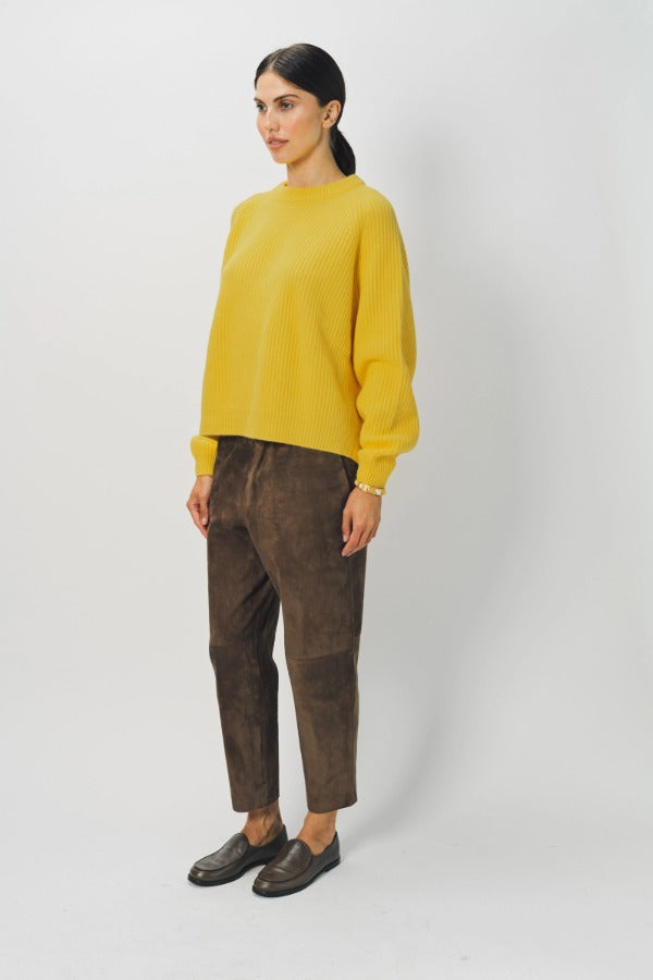 Side view of sunray ls crew neck sweater on model wearing brown pants and loafers, against a white background.