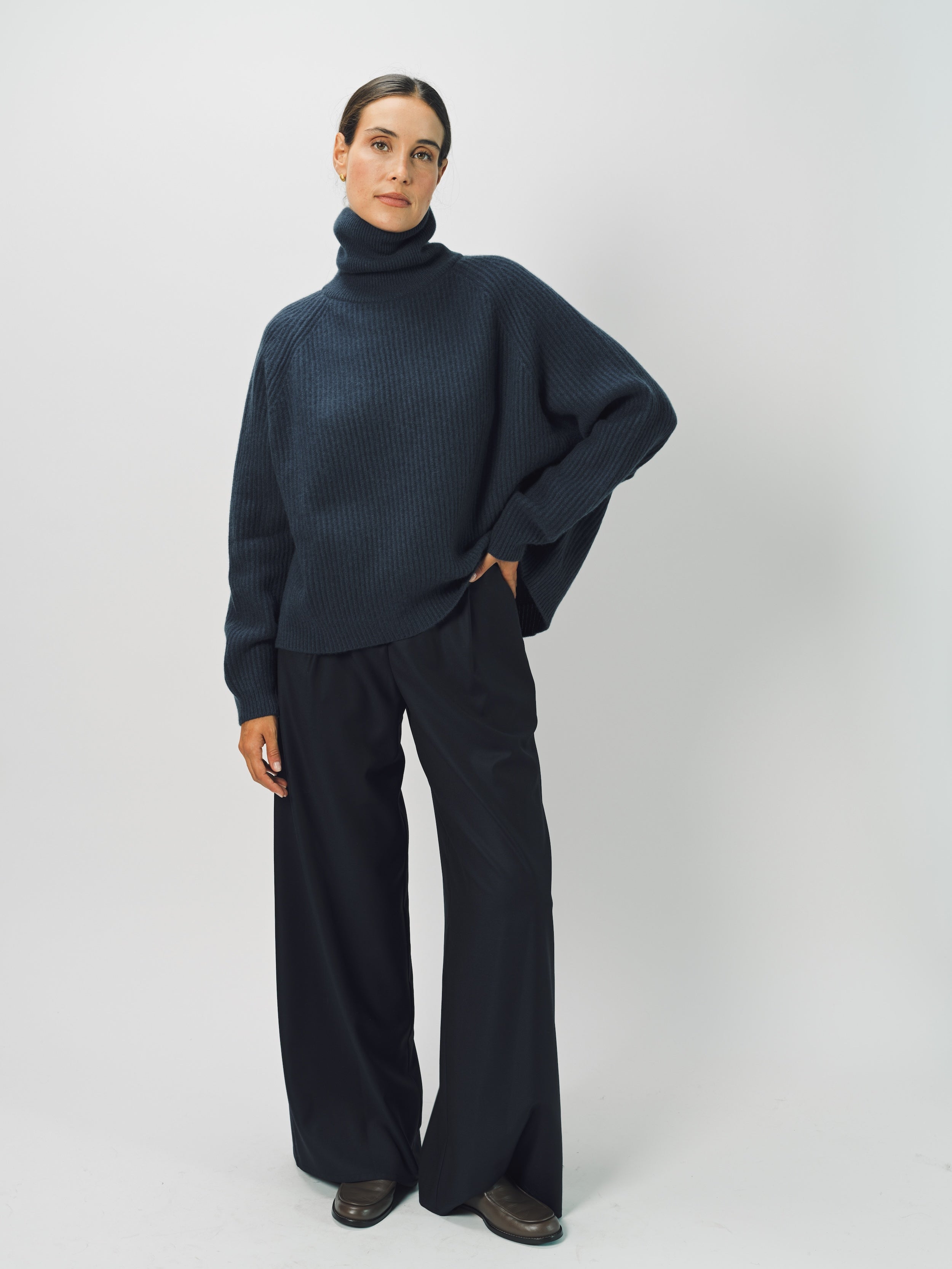 Front view of midnight ls t-neck raglan sweater on model wearing navy pants, against a white background.