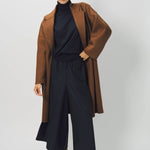 Alternate front view of palissandro oversized coat on model wearing navy turtleneck, pants and loafers, against a white background.