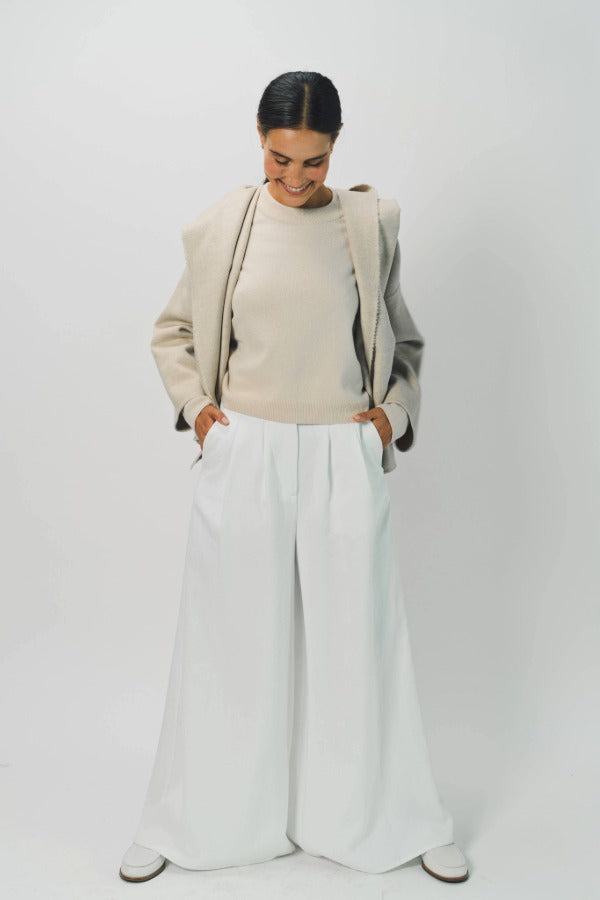 Front view of white cotton gaucho pant on model wearing vanilla top, against white background.
