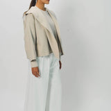 Side view of white gaucho cotton pant on model wearing vanilla top, against a white background.