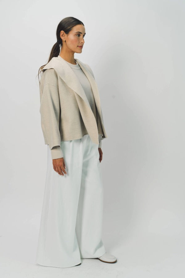 Side view of white gaucho cotton pant on model wearing vanilla top, against a white background.