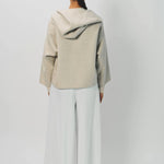 Back view of white cotton gaucho pant on model wearing vanilla top, against a white background.