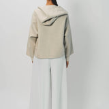 Back view of white cotton gaucho pant on model wearing vanilla top, against a white background.