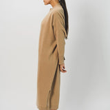 Side view of bronzo iconic cashmere dress on model wearing loafers, against a white background.