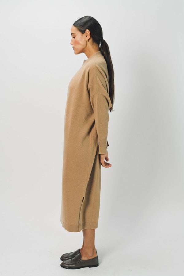 Side view of bronzo iconic cashmere dress on model wearing loafers, against a white background.