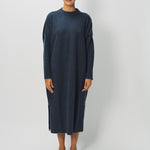 Front view of pacific iconic cashmere dress on model wearing loafers, against a white background.
