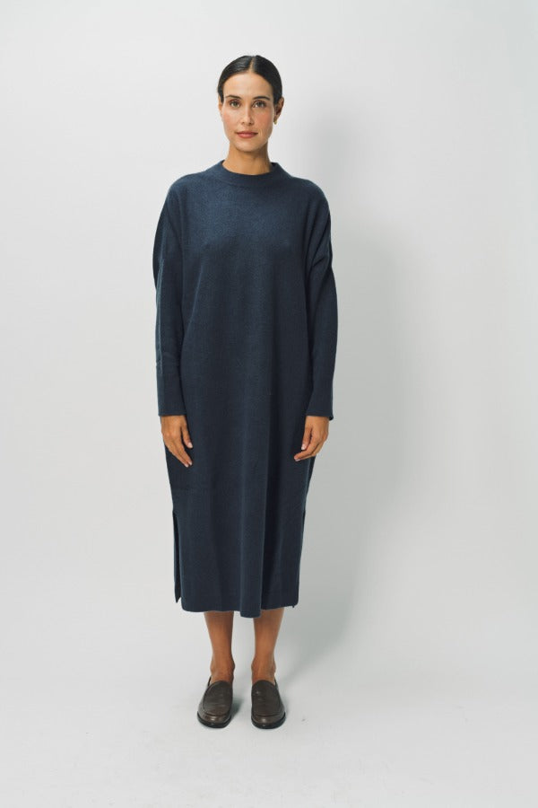 Front view of pacific iconic cashmere dress on model wearing loafers, against a white background.
