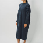 Side view of pacific iconic cashmere dress on model wearing loafers, against a white background.