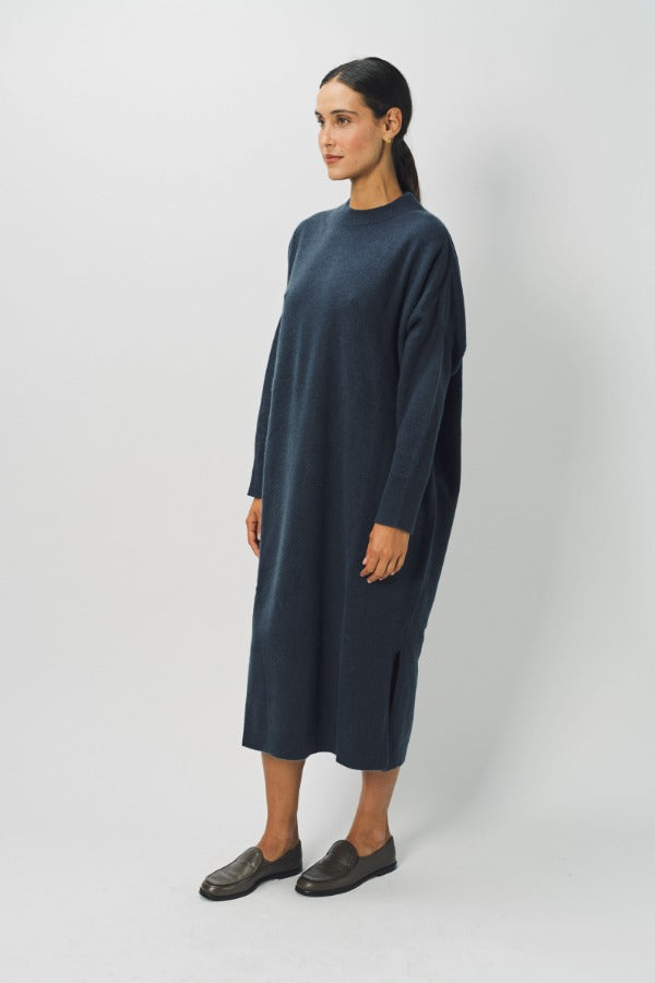 Side view of pacific iconic cashmere dress on model wearing loafers, against a white background.