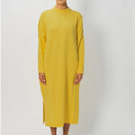 Front view of sunray iconic cashmere dress on model wearing loafers, against a white background.