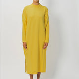 Front view of sunray iconic cashmere dress on model wearing loafers, against a white background.