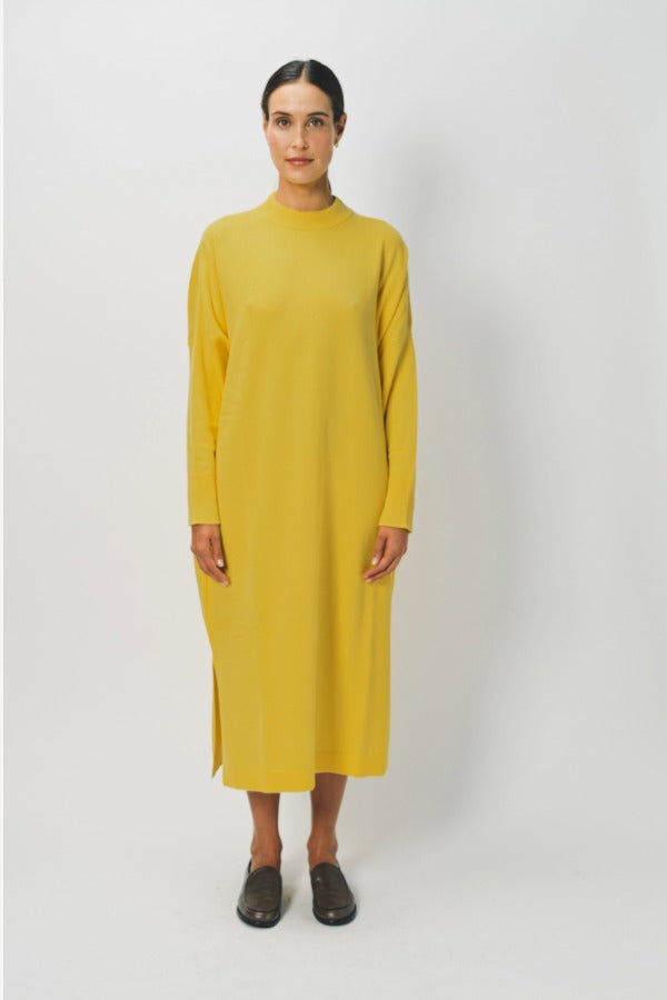 Front view of sunray iconic cashmere dress on model wearing loafers, against a white background.