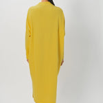 Back view of sunray iconic cashmere dress on model wearing loafers, against a white background.