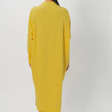 Back view of sunray iconic cashmere dress on model wearing loafers, against a white background.