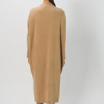 Back view of bronzo iconic cashmere dress on model wearing loafers, against a white background.