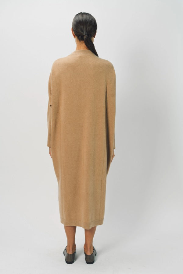 Back view of bronzo iconic cashmere dress on model wearing loafers, against a white background.