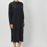 Front view of black wood iconic cashmere dress on model wearing loafers, against a white background.