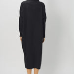 Back view of black wood iconic cashmere dress on model wearing loafers, against a white background.