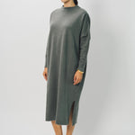 Side view of storm iconic cashmere dress on model wearing loafers, against a white background.