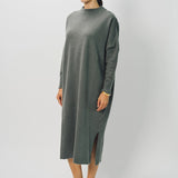 Side view of storm iconic cashmere dress on model wearing loafers, against a white background.