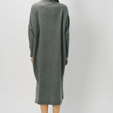 Back view of storm iconic cashmere dress on model wearing loafers, against a white background.